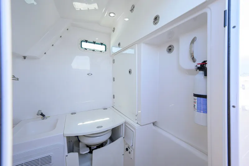 Slide: The Image of Interior of 2018 Everglades 355 Center Console boat bathroom with sink and fire extinguisher. - 51