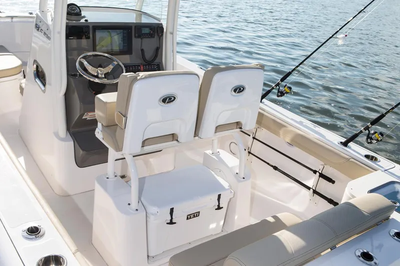 Slide: The Image of Manufacturer Provided Image: 2017 Pursuit C 238 Center Console boat interior with fishing rods and seating. - 7