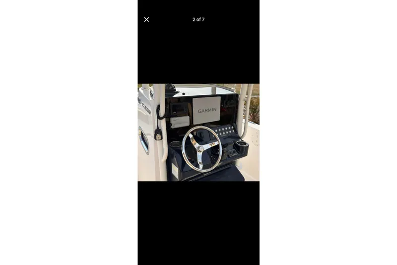Slide: The Image of 2017 Pursuit C 238 Center Console boat dashboard with Garmin navigation system. - 2