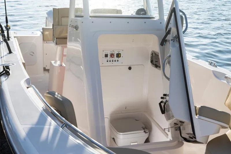 Slide: The Image of Manufacturer Provided Image: 2017 Pursuit C 238 Center Console boat interior with open console door. - 8