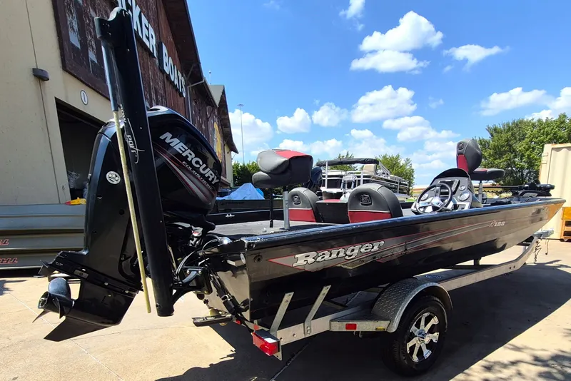 Slide: The Image of 2019 Ranger RT188 boat with Mercury engine, parked outdoors under a clear blue sky. - 6