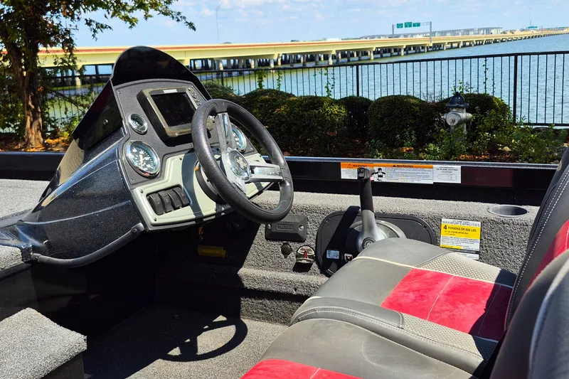 Slide: The Image of 2019 Ranger RT188 boat cockpit with steering wheel and controls by the water. - 11