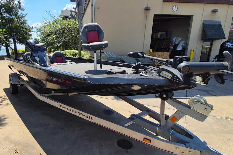 Slide: The Image of 2019 Ranger RT188 boat on trailer, parked outdoors near a building. - 4