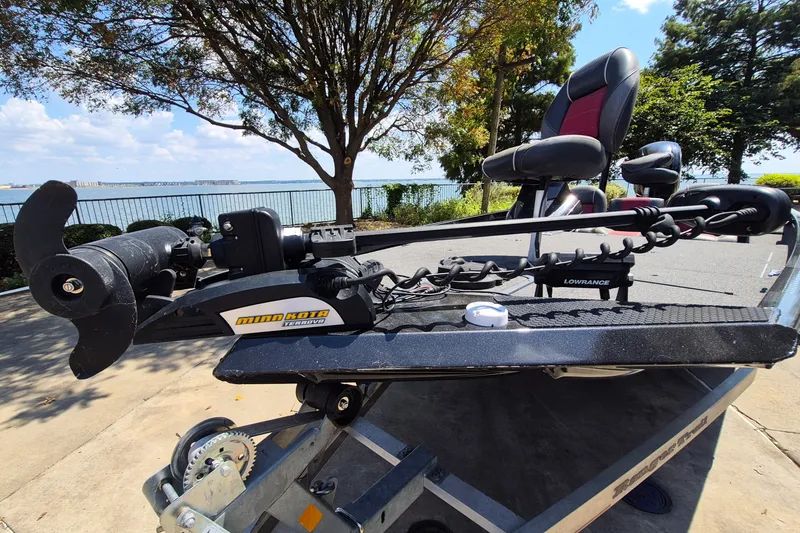 Slide: The Image of 2019 Ranger RT188 boat with Minn Kota Terrova motor and Lowrance system by a lakeside. - 2