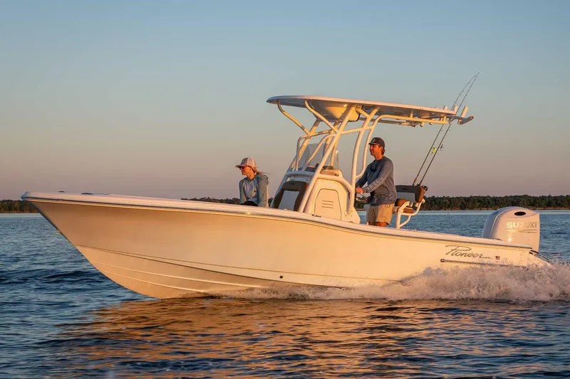 The Image of Manufacturer Provided Image: 2025 Pioneer 220 Bay Sport boat cruising on calm water at sunset. - 0