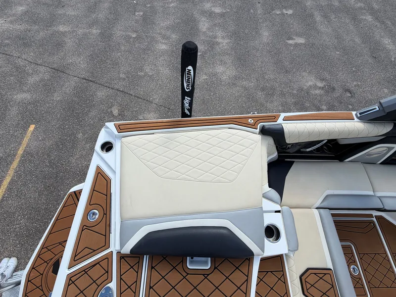 Slide: The Image of The image shows the deck of a 2019 Tigé 20RZX boat with cushioned seats and wood accents. - 19