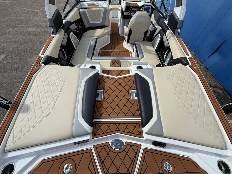 Slide: The Image of Interior of a 2019 Tigé 20RZX with sleek seating and wood flooring. - 13