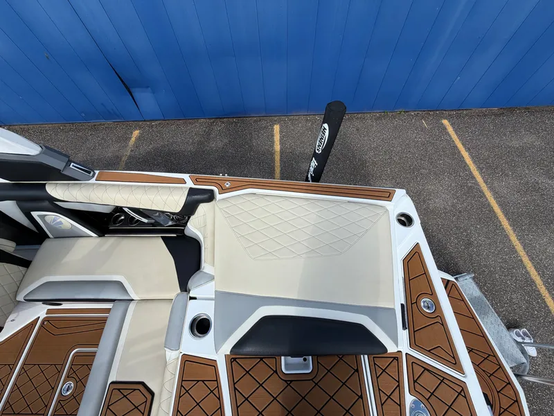 Slide: The Image of The image shows the deck of a 2019 Tigé 20RZX with cushioned seats and wood patterning. - 17