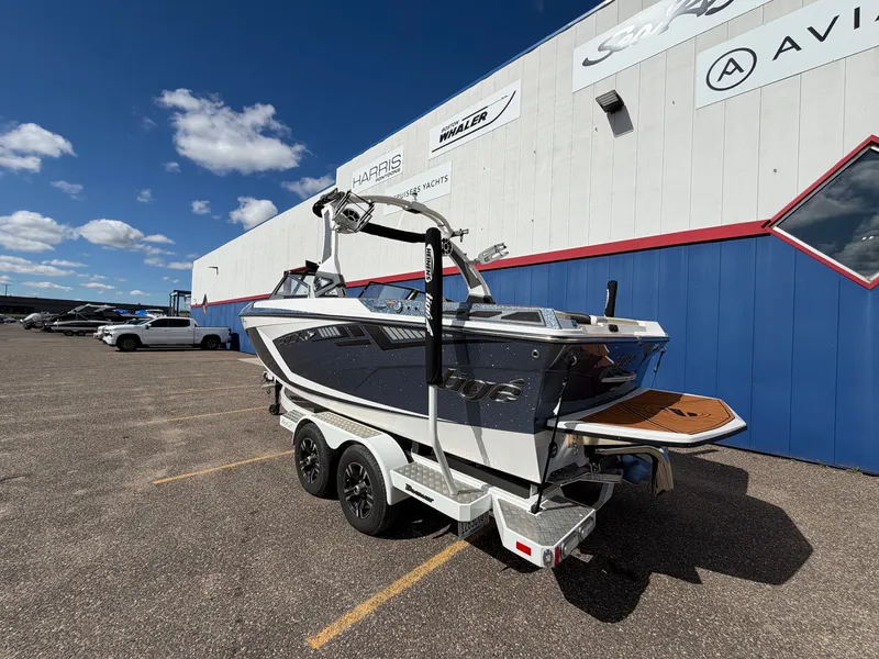 Slide: The Image of A 2019 Tigé 20RZX boat on a trailer in front of a building. - 4