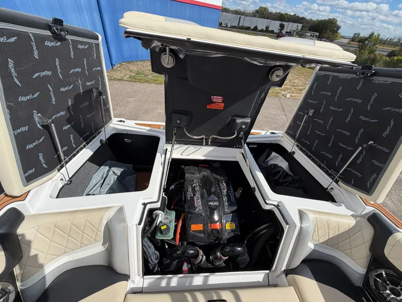 Slide: The Image of The 2019 Tigé 20RZX features an open engine compartment with a powerful engine and storage space. - 7