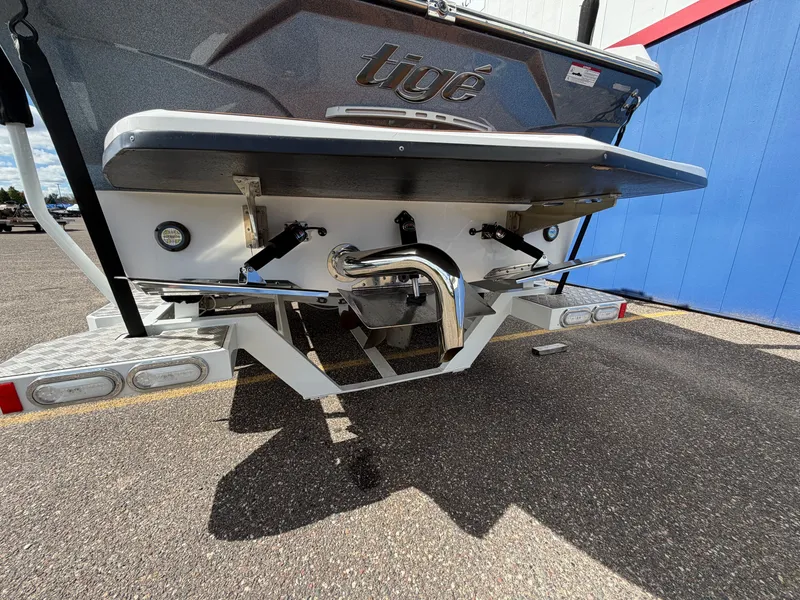 Slide: The Image of The stern of a 2019 Tigé 20RZX with polished exhaust and trim tabs. - 5