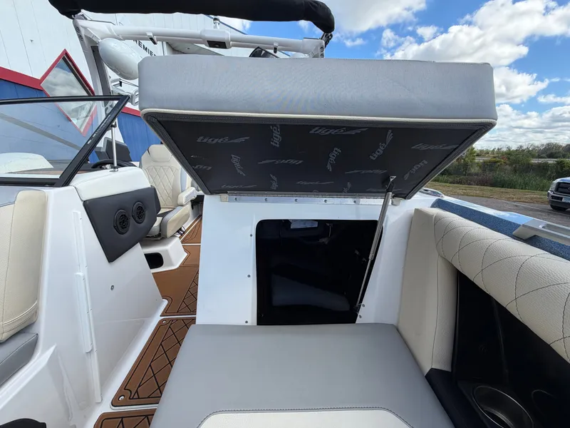 Slide: The Image of The image shows the interior of a 2019 Tigé 20RZX with a seat lifted to reveal storage. - 42