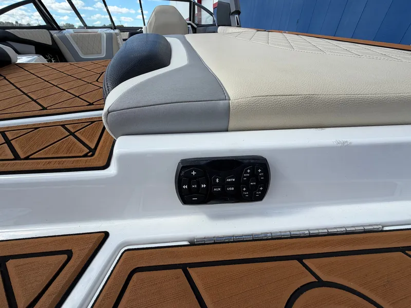 Slide: The Image of Close-up of a 2019 Tigé 20RZX deck with controls and upholstery. - 10