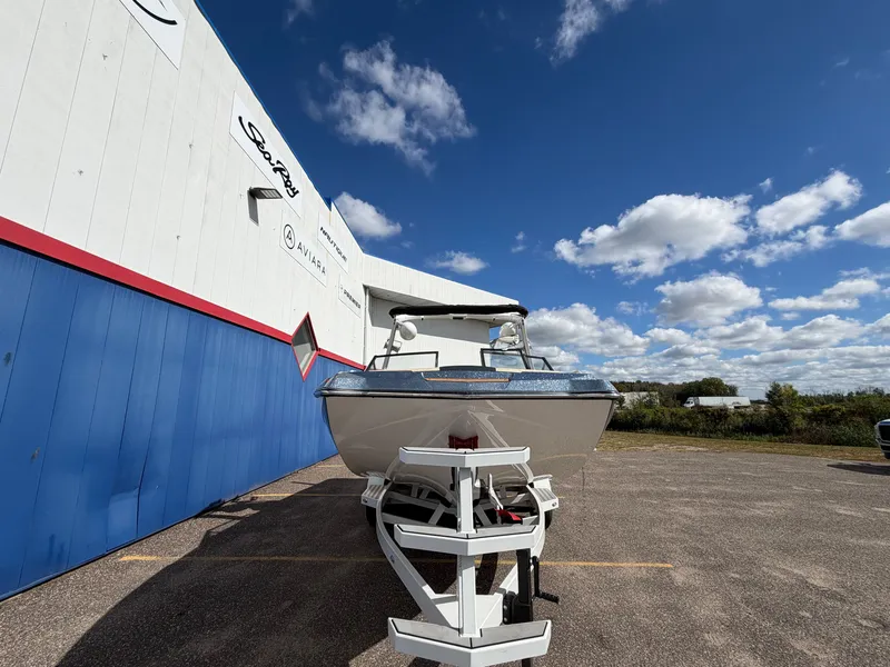 Slide: The Image of A 2019 Tigé 20RZX boat on a trailer in front of a building with blue and white walls. - 3