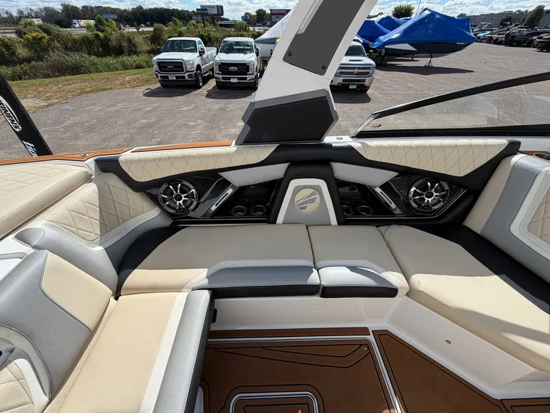 Slide: The Image of Interior view of a 2019 Tigé 20RZX with cushioned seating and speakers. - 29