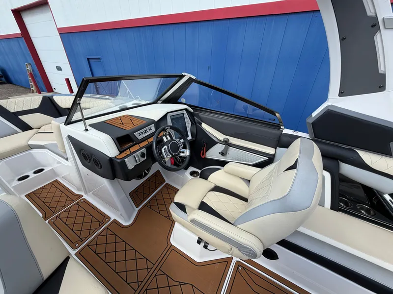 Slide: The Image of The image shows the cockpit of a 2019 Tigé 20RZX boat with modern controls and luxurious seating. - 32