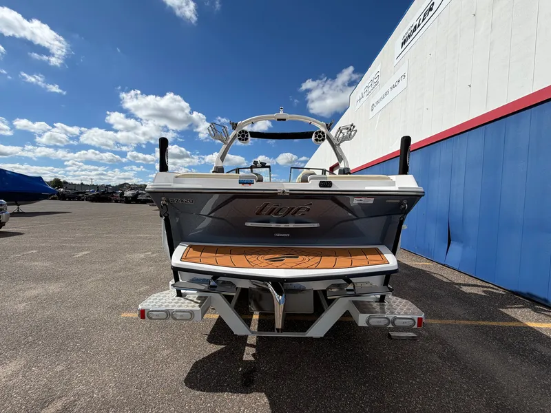 Slide: The Image of The image shows the rear of a 2019 Tigé 20RZX boat in a parking lot. - 6