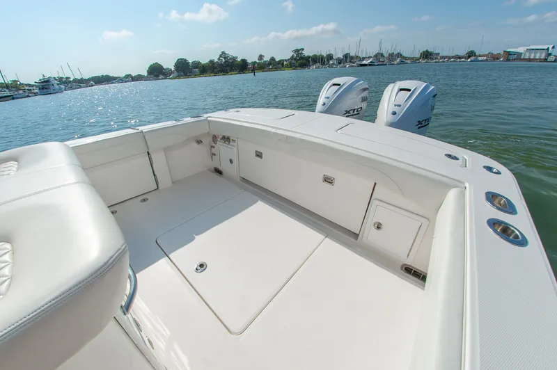 Slide: The Image of The image shows the spacious aft deck of a 2024 Regulator 31 boat with twin outboard engines. - 7