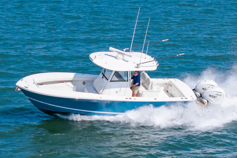 Slide: The Image of 2024 Regulator 31 on the water with dual outboard engines. - 1
