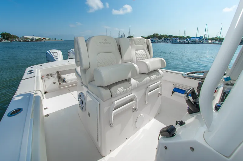 Slide: The Image of The image shows the cockpit of a 2024 Regulator 31 boat with luxurious white seating. - 12
