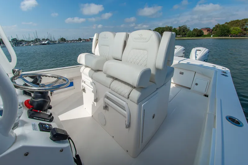 Slide: The Image of The image shows the cockpit of a 2024 Regulator 31 boat with white cushioned seats. - 13