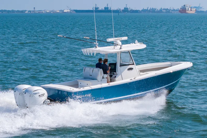 Slide: The Image of 2024 Regulator 31 on the water with dual outboard engines. - 23