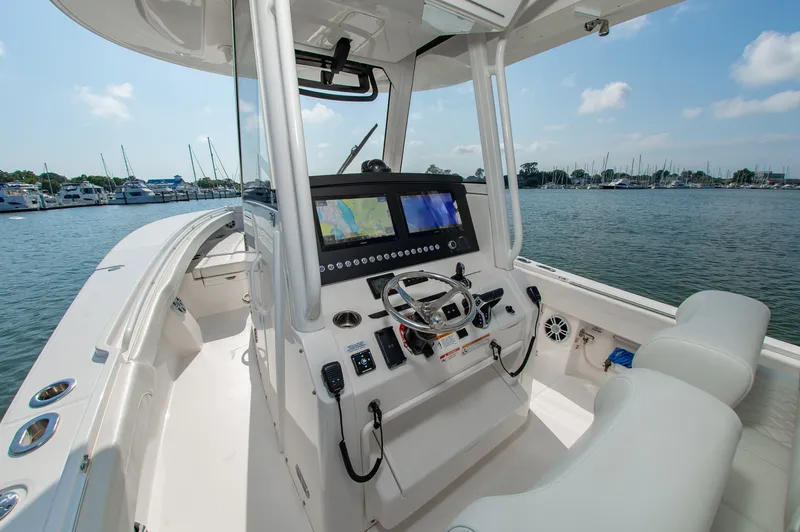 Slide: The Image of The image shows the cockpit of a 2024 Regulator 31 boat with modern electronics. - 15