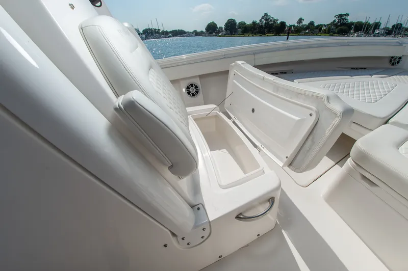 Slide: The Image of The image shows the seating area of a 2024 Regulator 31 boat with storage underneath. - 19