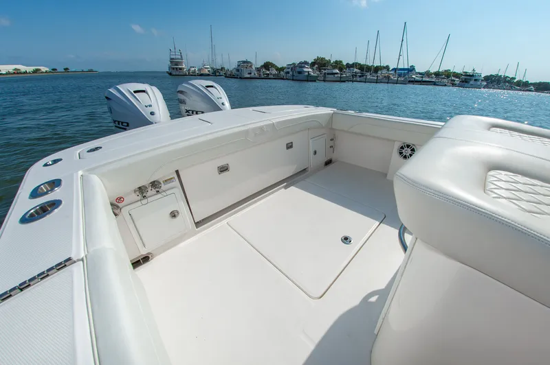 Slide: The Image of The image shows the cockpit of a 2024 Regulator 31 boat with twin outboard engines in the background. - 9