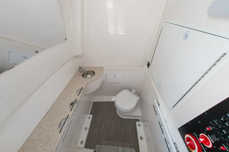 Slide: The Image of Interior view of a boat bathroom with sink, toilet, and storage space. - 21