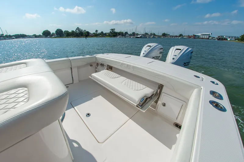 Slide: The Image of The image shows the stern of a 2024 Regulator 31 boat with two engines and a bench seat. - 8