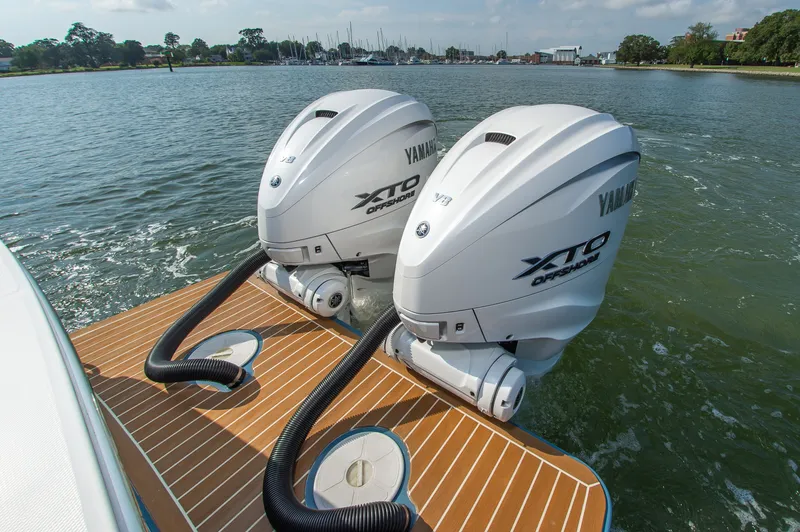 Slide: The Image of Two Yamaha XTO outboard engines on a Regulator 31 boat in calm waters. - 11