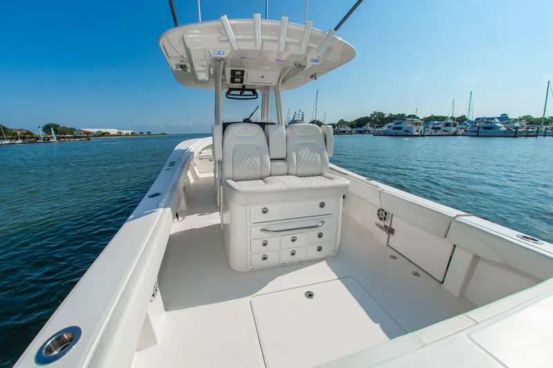 Slide: The Image of The image shows a modern boat with white upholstery and a clear, sunny sky in the background. - 3