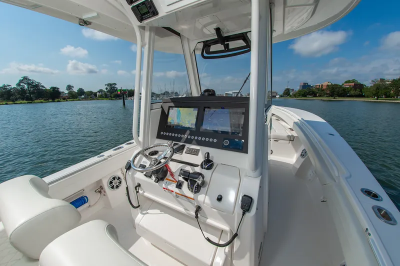 Slide: The Image of The image shows the cockpit of a 2024 Regulator 31 boat with modern electronics and controls. - 14