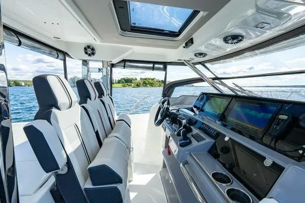 Slide: The Image of Interior view of 2021 Jeanneau Leader 12.5 WA boat with modern cockpit and seating. - 13