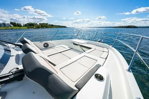 Slide: The Image of 2021 Jeanneau Leader 12.5 WA boat with spacious deck seating on a sunny day. - 4