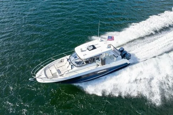 Slide: The Image of 2021 Jeanneau Leader 12.5 WA cruising on open water, aerial view. - 6