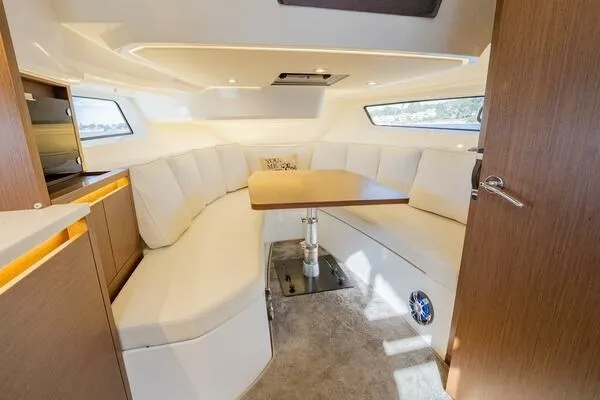 Slide: The Image of Luxurious interior of 2021 Jeanneau Leader 12.5 WA with elegant seating and table. - 8