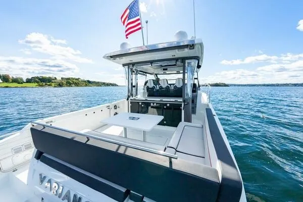 Slide: The Image of 2021 Jeanneau Leader 12.5 WA boat on water, American flag, sunny day. - 3