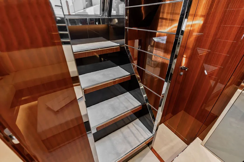 Slide: The Image of Staircase with sleek wood and chrome finish inside 2019 Riva 56' Rivale yacht. - 29