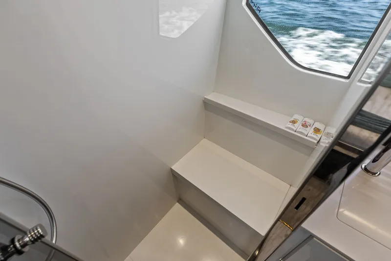 Slide: The Image of Interior of 2019 Riva 56' Rivale yacht with sleek white design and window view. - 48