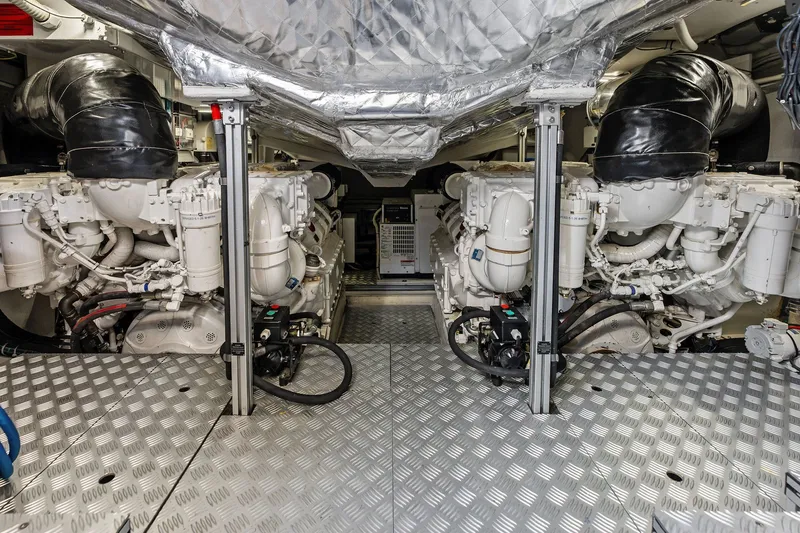 Slide: The Image of Engine room of 2019 Riva 56' Rivale yacht, showcasing dual engines and metallic flooring. - 54