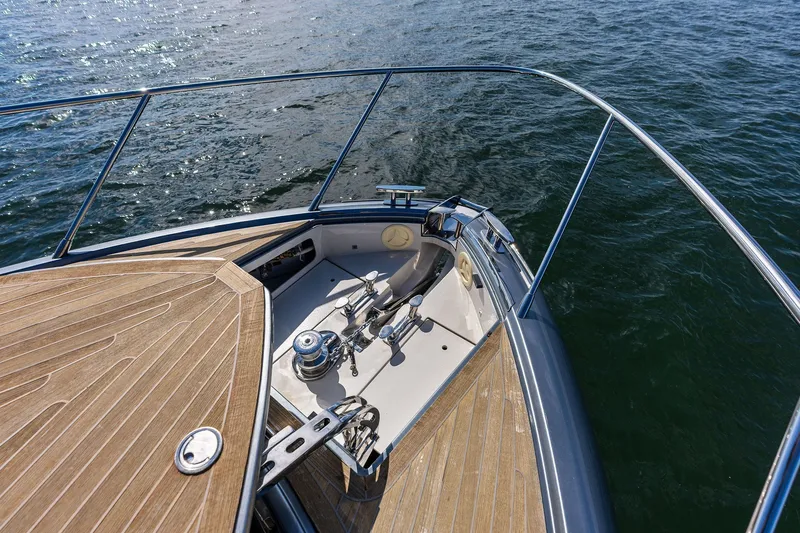 Slide: The Image of Bow view of 2019 Riva 56' Rivale yacht with teak decking on water. - 16