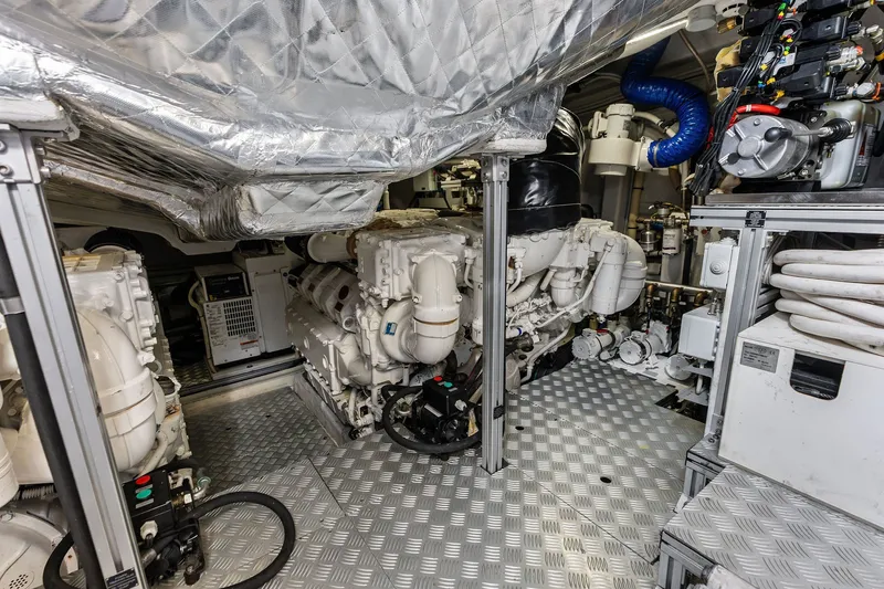 Slide: The Image of Engine room of a 2019 Riva 56' Rivale yacht, showcasing machinery and equipment. - 56