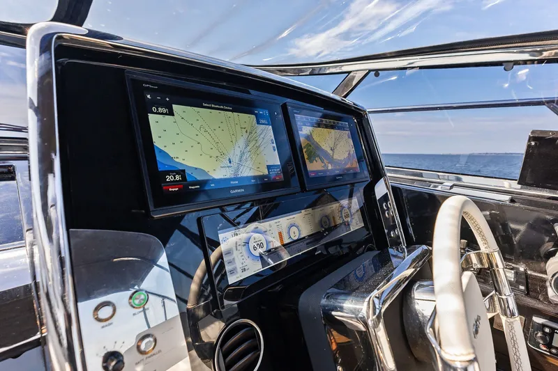 Slide: The Image of 2019 Riva 56' Rivale yacht cockpit with navigation screens and steering wheel. - 22