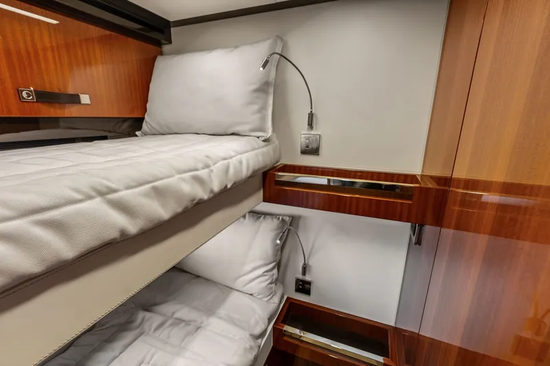 Slide: The Image of Luxurious 2019 Riva 56' Rivale yacht cabin with elegant wooden finishes and cozy bunk beds. - 50