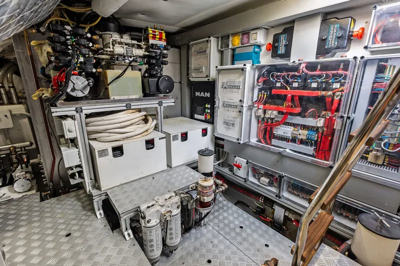 Slide: The Image of Engine room of a 2019 Riva 56' Rivale yacht, showcasing complex machinery and wiring. - 53