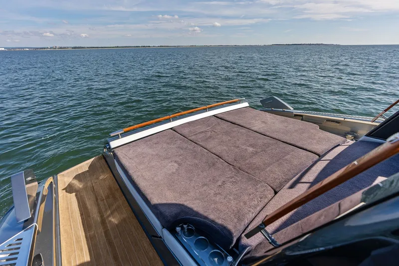 Slide: The Image of 2019 Riva 56' Rivale yacht with sunbed, overlooking serene ocean waters. - 27