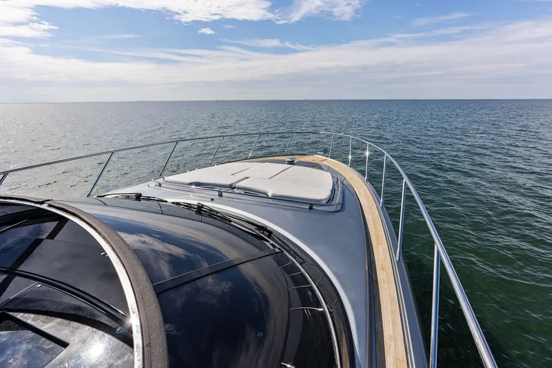 Slide: The Image of 2019 Riva 56' Rivale yacht cruising on open sea under blue sky. - 14