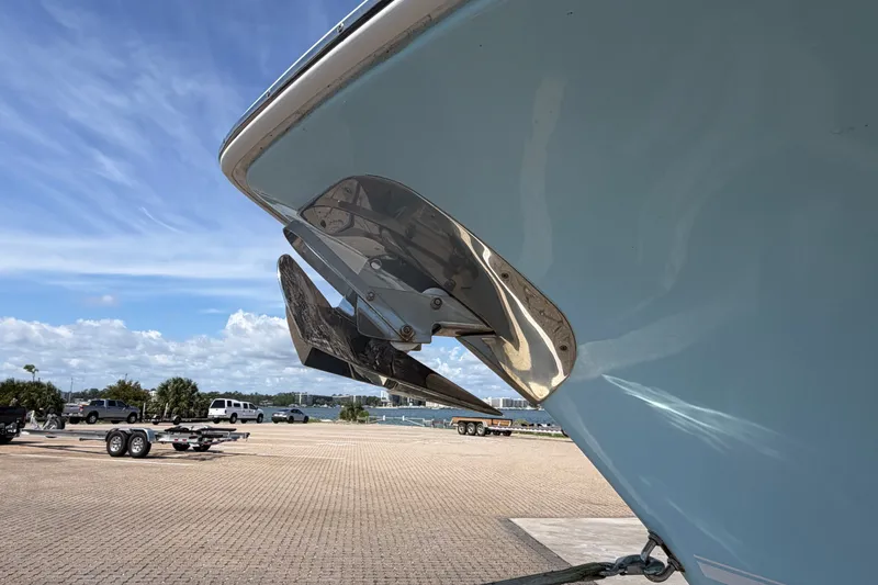Slide: The Image of 2023 Tidewater 292 CC Adventure boat with stainless steel anchor, parked on a sunny day. - 26